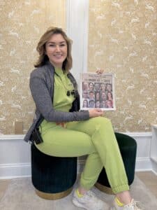 Dr. Julia Giardina, Board-Certified family orthodontist in Harrisonburg VA, holding Daily News-Record 15 Under 50 award recognition at Giardina Orthodontics office