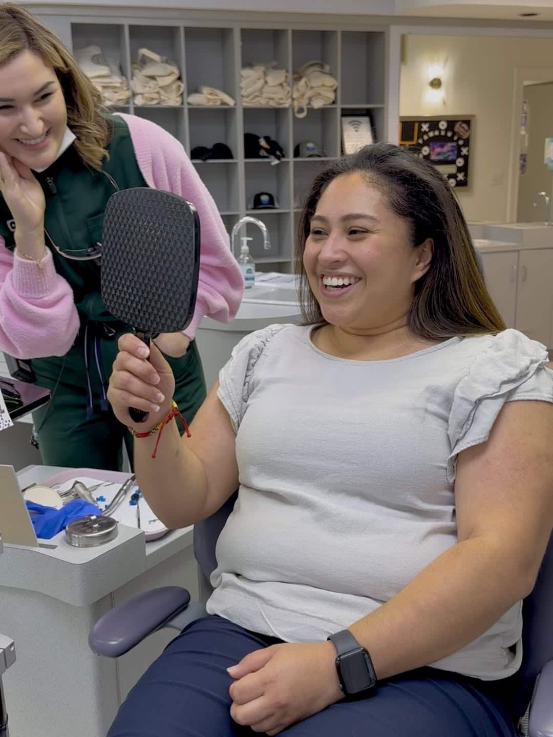 Happy patient seeing her smile transformation for the first time after braces removal at Giardina Orthodontics in Harrisonburg, VA