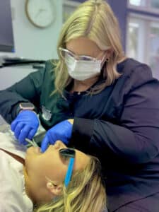Board-certified orthodontist Dr. Giardina's staff adjusting braces for a young athlete at Giardina Orthodontics in Harrisonburg, Virginia