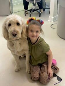 Young patient with Jerry the therapy dog at Giardina Orthodontics near Grottoes VA - board-certified orthodontist for kids