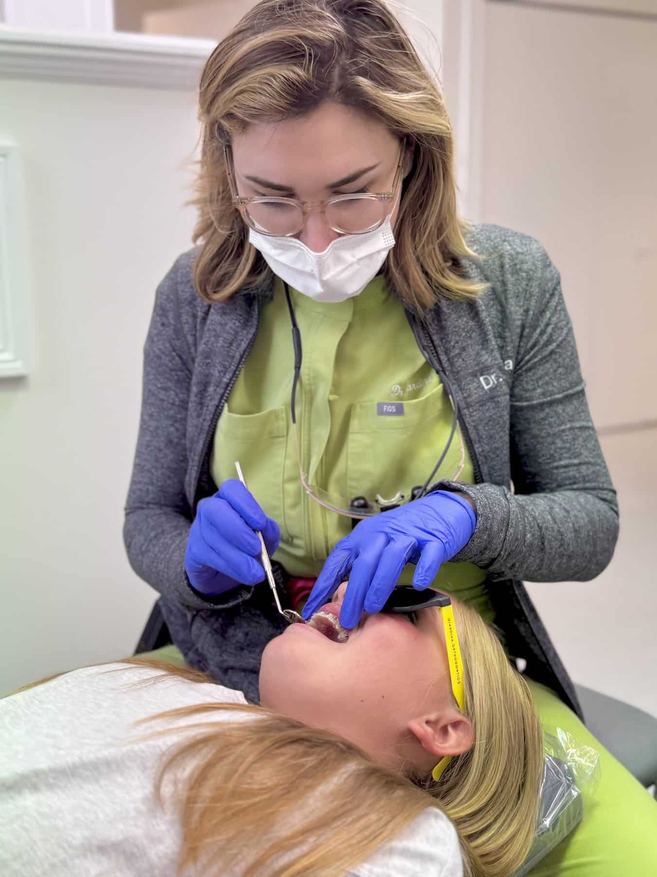An orthodontist at Giardina Orthodontics adjusts a patient's braces during crooked teeth treatment in Harrisonburg, VA.